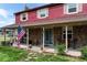 Charming front porch with stone accents, American flag, and a glass front door, enhancing the home's curb appeal at 20155 E Davies Ave, Centennial, CO 80016