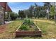 This backyard features a delightful raised garden with a variety of plants and greenery at 20155 E Davies Ave, Centennial, CO 80016