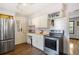 Bright kitchen with stainless steel appliances, modern cabinets, and hardwood floors at 20155 E Davies Ave, Centennial, CO 80016