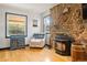 Charming living room featuring stone fireplace, hardwood floors, and natural light at 20155 E Davies Ave, Centennial, CO 80016