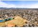 Expansive aerial view of a community with tennis courts, baseball fields, and mountain backdrop at 7197 S Newland St, Littleton, CO 80128