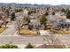 Aerial view of a residential neighborhood with tree-lined streets and mountain views in the distance at 7197 S Newland St, Littleton, CO 80128