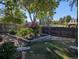 Landscaped backyard features a raised garden bed, wooden fence, and mature trees at 7197 S Newland St, Littleton, CO 80128