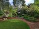 Lush backyard featuring a manicured lawn, decorative bird bath, and stone-lined flower beds at 7197 S Newland St, Littleton, CO 80128