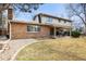 Exterior view of the home showcasing the patio and well-maintained backyard at 7197 S Newland St, Littleton, CO 80128