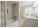 Bright bathroom features tile flooring, a shower-tub combo, and a granite countertop vanity at 7197 S Newland St, Littleton, CO 80128