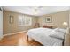 Bright bedroom featuring hardwood floors, a ceiling fan, and a window with shutter blinds at 7197 S Newland St, Littleton, CO 80128