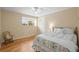 Cozy bedroom with hardwood floors, a ceiling fan, and a large window bringing in natural light at 7197 S Newland St, Littleton, CO 80128