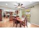 Dining room showcasing hardwood floors, and easy access to the kitchen and outdoor patio at 7197 S Newland St, Littleton, CO 80128