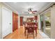 Bright dining area with hardwood floors, a ceiling fan, and a sliding glass door to the outdoor patio at 7197 S Newland St, Littleton, CO 80128