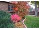 Attractive landscaping with colorful shrubs and a curved flower bed bordering the house at 7197 S Newland St, Littleton, CO 80128