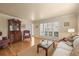 Cozy living room with hardwood floors, plantation shutters, and classic decor at 7197 S Newland St, Littleton, CO 80128