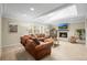 Inviting living room with a brick fireplace, leather sofas, and a bright, sunny atmosphere at 7197 S Newland St, Littleton, CO 80128