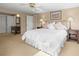 Comfortable and serene main bedroom with soft lighting, a ceiling fan, and double closets at 7197 S Newland St, Littleton, CO 80128