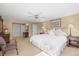 Spacious main bedroom featuring neutral tones, a ceiling fan, and double closets for ample storage at 7197 S Newland St, Littleton, CO 80128