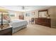 Cozy main bedroom featuring neutral tones, a ceiling fan, and ample natural light from the window at 7197 S Newland St, Littleton, CO 80128