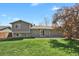 Spacious backyard with lush green grass, mature trees, and a well-maintained lawn at 8001 S Estes St, Littleton, CO 80128