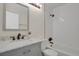 Charming bathroom featuring a stylish vanity with granite counters and a shower with white subway tile at 8001 S Estes St, Littleton, CO 80128