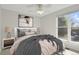 Staged bedroom features neutral walls, bedside tables and lamps, and window allowing natural light to filter through at 8001 S Estes St, Littleton, CO 80128