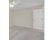 Empty bedroom includes neutral walls, neutral carpet, ceiling fan, and window allowing natural light to filter through at 8001 S Estes St, Littleton, CO 80128