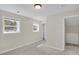 Well-lit bedroom with neutral walls, carpet floors, and two windows for natural light at 8001 S Estes St, Littleton, CO 80128