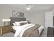 Staged bedroom includes bedside tables and lamps, and two pieces of modern art on the wall at 8001 S Estes St, Littleton, CO 80128