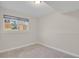 Well-lit bedroom with a large window, carpet flooring, and neutral-colored walls at 8001 S Estes St, Littleton, CO 80128