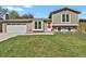 Charming two-story home with brick and siding exterior and well-maintained front yard at 8001 S Estes St, Littleton, CO 80128