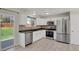 Updated kitchen boasts stainless steel appliances, white cabinets, and access to the backyard at 8001 S Estes St, Littleton, CO 80128