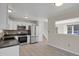 Bright kitchen features stainless steel appliances, modern cabinets, and beautiful flooring at 8001 S Estes St, Littleton, CO 80128