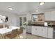 Bright kitchen featuring white cabinets, tile backsplash, stainless steel appliances, and sliding patio door at 8001 S Estes St, Littleton, CO 80128