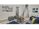 Staged living room featuring stairs to the second level and a pass through to the kitchen at 8001 S Estes St, Littleton, CO 80128