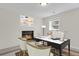 Bright home office featuring a cozy fireplace, modern desk, and comfortable seating at 8001 S Estes St, Littleton, CO 80128