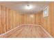 Finished basement with wood-look flooring, wood paneled walls, and recessed lighting at 2015 Elmira St, Aurora, CO 80010