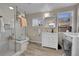 Bright bathroom with a glass-enclosed shower, modern fixtures, and a washing machine at 2015 Elmira St, Aurora, CO 80010