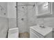 Bathroom boasts tiled shower and floors, modern vanity, and sleek fixtures at 2015 Elmira St, Aurora, CO 80010