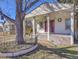 Inviting home exterior featuring a covered porch with supporting columns and a decorative front yard fence at 2015 Elmira St, Aurora, CO 80010