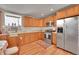 Well-lit kitchen featuring stainless steel appliances, wooden cabinets, and marble countertops at 2015 Elmira St, Aurora, CO 80010