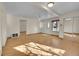 Bright living room with hardwood floors, ceiling fan, and a mirrored closet door, bathed in natural light at 2015 Elmira St, Aurora, CO 80010