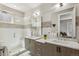 Modern bathroom featuring a glass-enclosed shower, dual sinks, updated fixtures, and tile accents at 1012 Bannock St, Denver, CO 80204