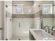 Updated bathroom with a glass-enclosed shower, sleek vanity, modern hardware, and tiled walls at 1012 Bannock St, Denver, CO 80204