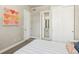 Cozy bedroom with bright painting, ensuite bathroom access, closet, and plush bedding at 1012 Bannock St, Denver, CO 80204
