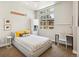 Bright bedroom with a large window, modern decor, and a comfortable workspace, filled with natural light at 1012 Bannock St, Denver, CO 80204