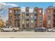Contemporary brick building with stone accents, multiple balconies, and a street view at 1012 Bannock St, Denver, CO 80204