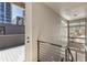 Hallway and staircase leading to the rooftop deck with views of city buildings, and large modern lighting fixture at 1012 Bannock St, Denver, CO 80204