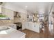 Well-lit kitchen with stainless appliances, light countertops, mosaic backsplash, and an open floorplan at 1012 Bannock St, Denver, CO 80204