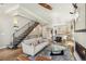 Living area with hardwood floors leads to open kitchen and staircase at 1012 Bannock St, Denver, CO 80204