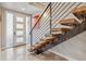 Modern staircase with wooden steps and steel railings at 1012 Bannock St, Denver, CO 80204