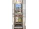 Staircase with large window offering outdoor views and architectural lighting fixture at 1012 Bannock St, Denver, CO 80204