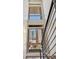 Staircase with a large, multi-pane window that offers views of the surrounding urban landscape at 1012 Bannock St, Denver, CO 80204